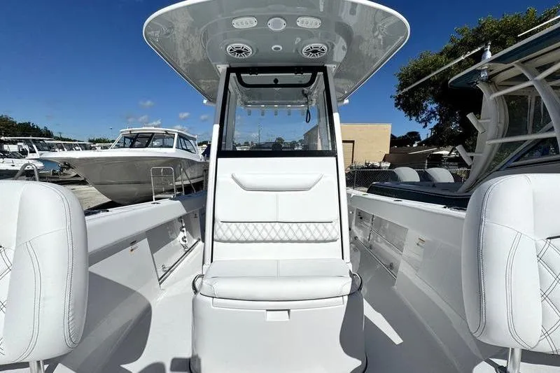 Slide: The Image of 2026 Sportsman Heritage 261 Center Console boat interior with white seating and modern design. - 13