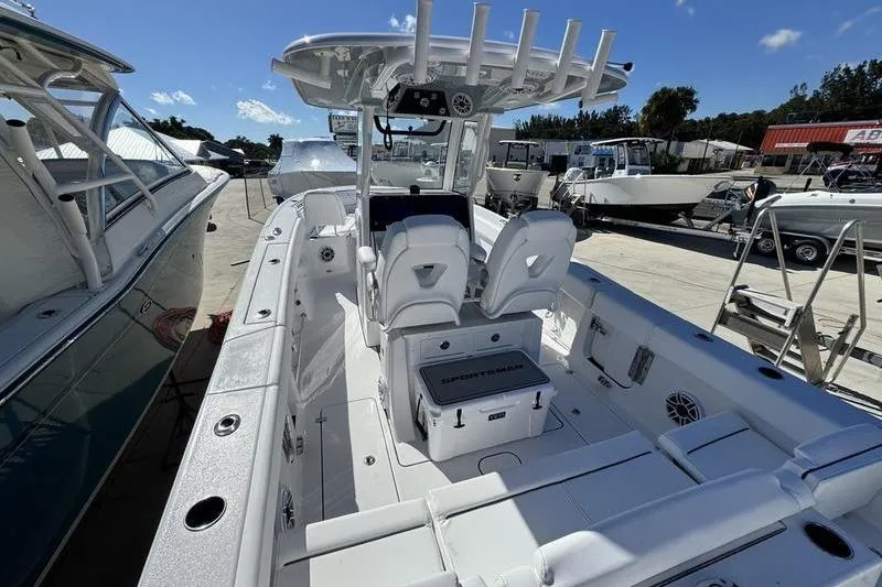 Slide: The Image of 2026 Sportsman Heritage 261 Center Console boat with sleek design and spacious deck. - 14