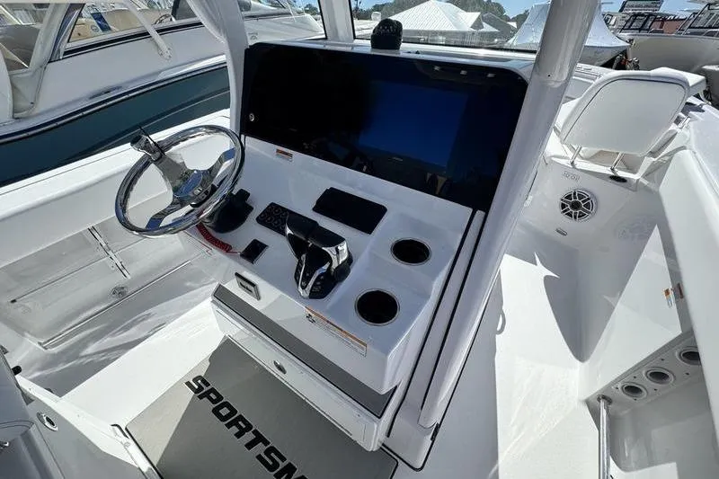Slide: The Image of 2026 Sportsman Heritage 261 Center Console boat dashboard with steering wheel and controls. - 15
