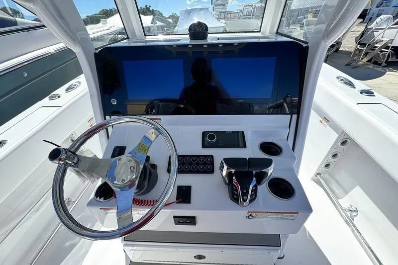 Slide: The Image of 2026 Sportsman Heritage 261 Center Console helm with modern controls and dual screens. - 17