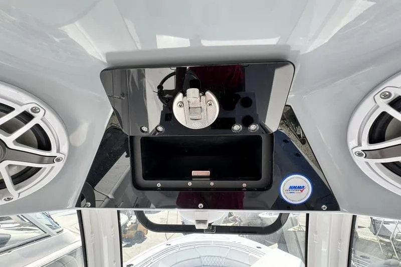 Slide: The Image of 2026 Sportsman Heritage 261 Center Console dashboard with speakers and storage compartment. - 22