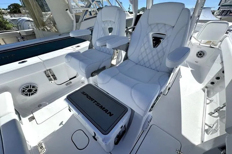Slide: The Image of 2026 Sportsman Heritage 261 Center Console boat interior with luxurious white seating. - 29