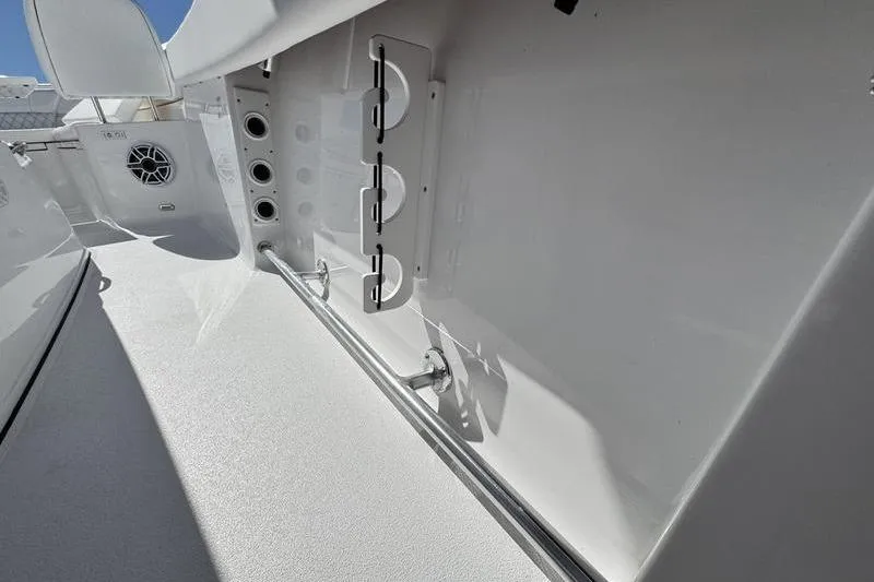 Slide: The Image of 2026 Sportsman Heritage 261 Center Console interior with rod holders and speaker. - 30