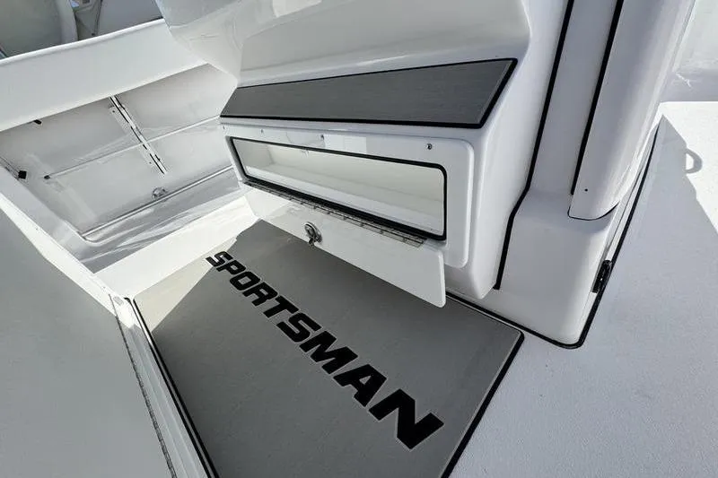 Slide: The Image of 2026 Sportsman Heritage 261 Center Console interior with storage compartment and branded mat. - 31