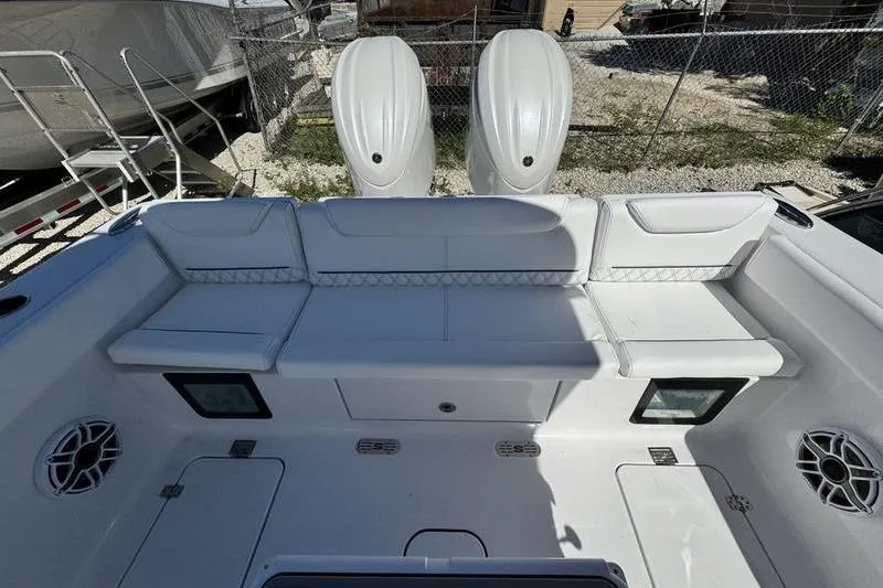 Slide: The Image of 2026 Sportsman Heritage 261 Center Console boat interior with seating and dual engines. - 35