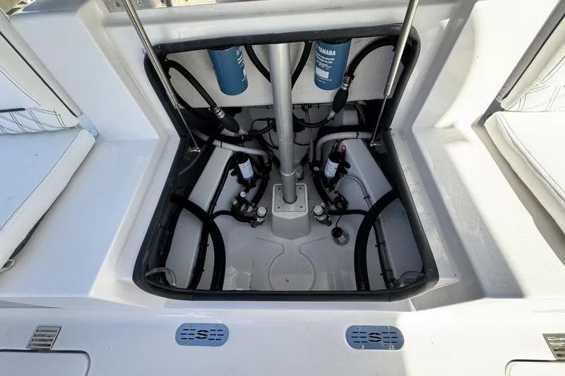 Slide: The Image of 2026 Sportsman Heritage 261 Center Console boat engine compartment with visible hoses and filters. - 36