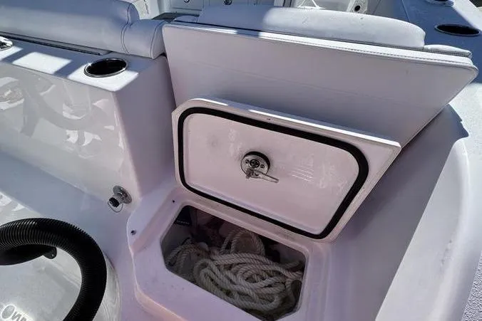 Slide: The Image of 2026 Sportsman Heritage 261 Center Console boat storage compartment with ropes inside. - 38