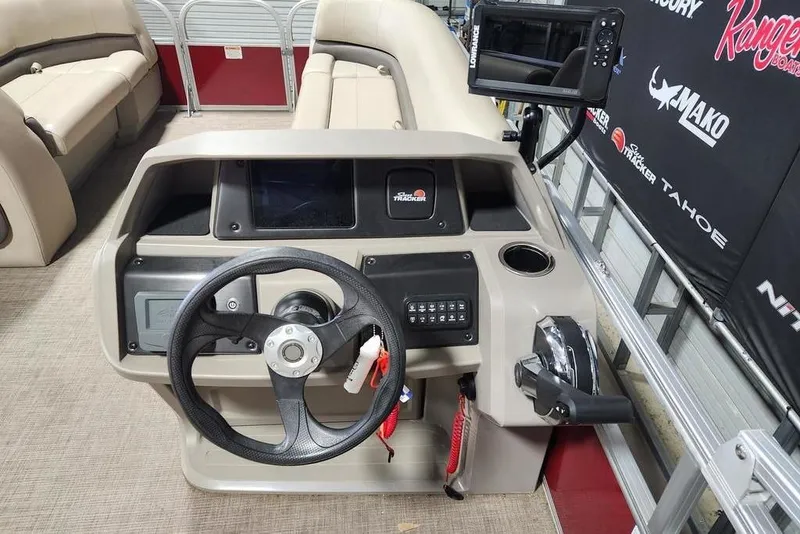 Slide: The Image of 2024 Sun Tracker Party Barge 18 DLX helm with steering wheel and control panel. - 10