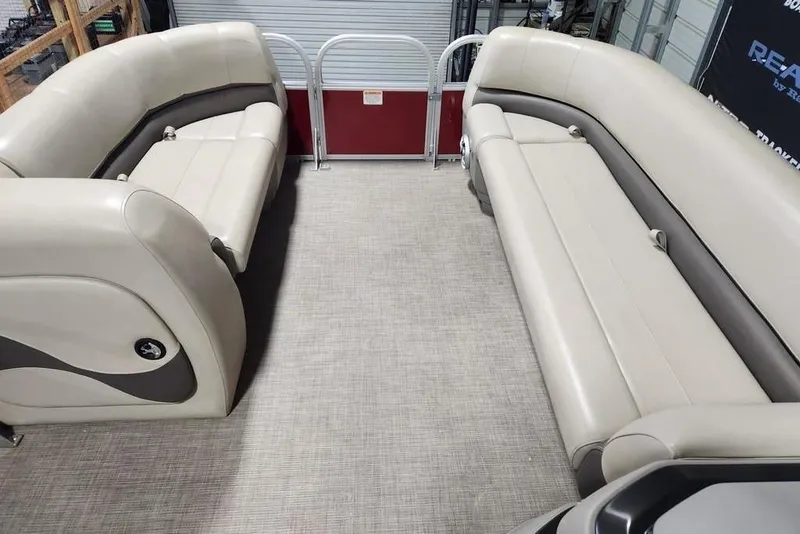 Slide: The Image of 2024 Sun Tracker Party Barge 18 DLX interior with beige seating and spacious layout. - 7