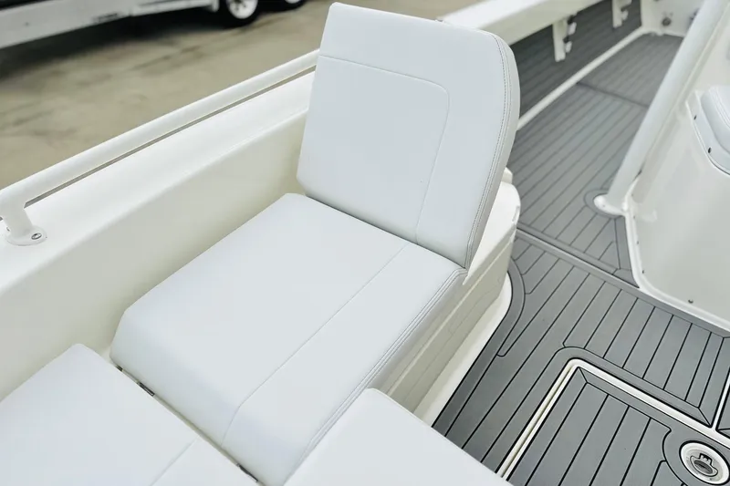 Slide: The Image of 2025 Pathfinder 2600 TRS boat interior with white seating and gray deck flooring. - 14
