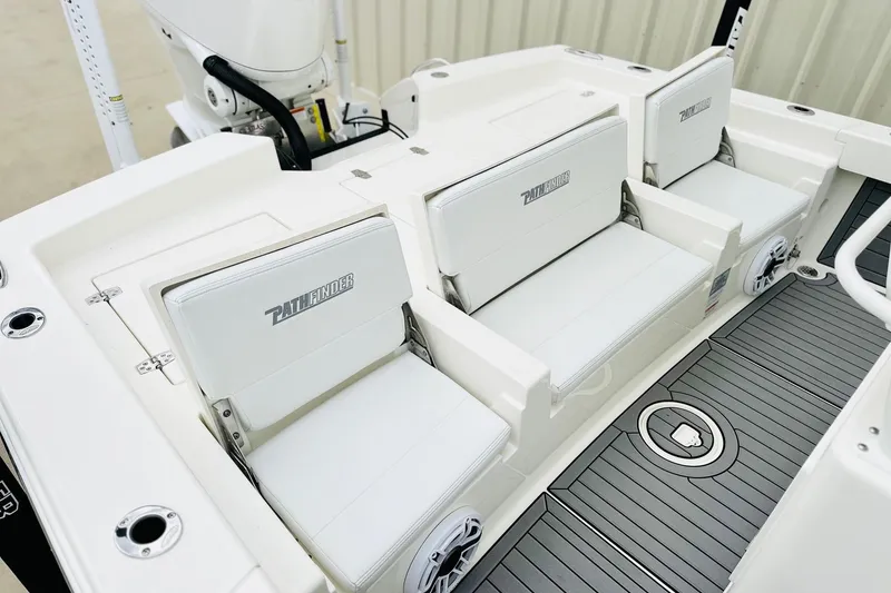 Slide: The Image of 2025 Pathfinder 2600 TRS boat interior with white seating and sleek deck design. - 22