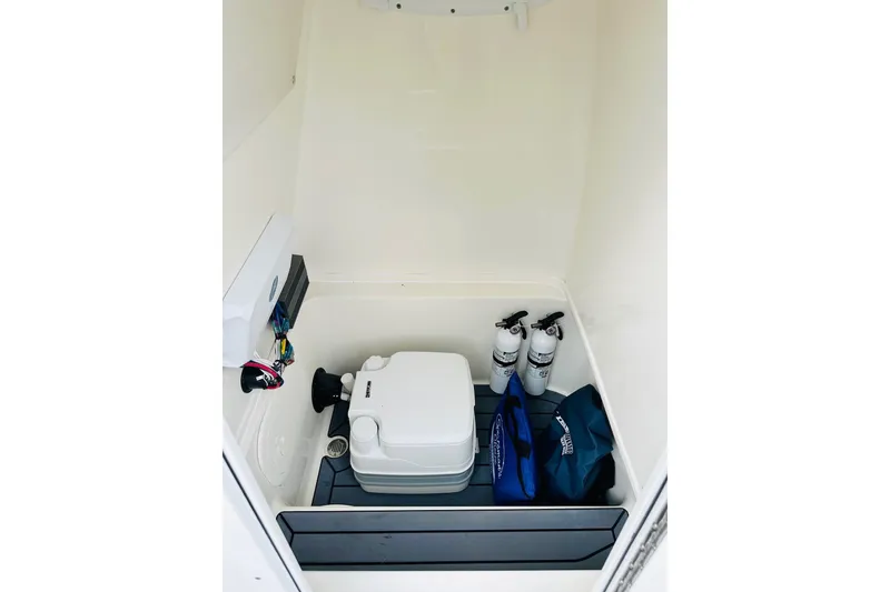 Slide: The Image of 2025 Pathfinder 2600 TRS storage compartment with portable toilet and safety equipment. - 24