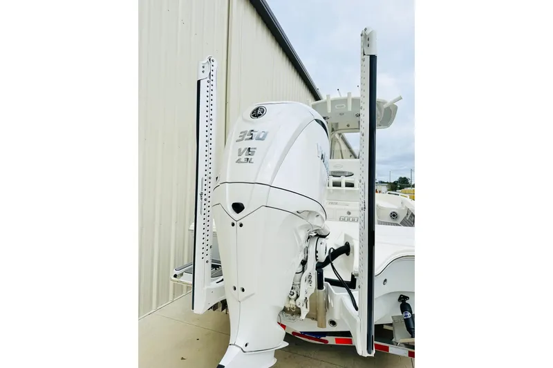 Slide: The Image of 2025 Pathfinder 2600 TRS boat with Yamaha 350 V6 engine, docked outdoors. - 25