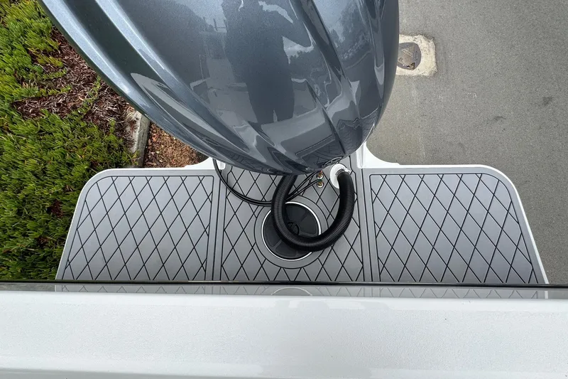 Slide: The Image of Rear view of 2026 Defiance Admiral 220 EX boat with outboard motor and diamond-patterned deck. - 11