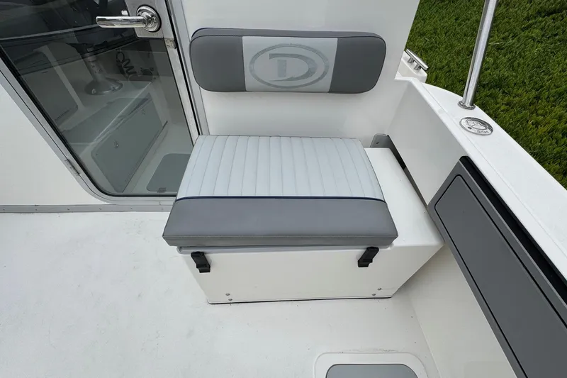 Slide: The Image of 2026 Defiance Admiral 220 EX boat seat with storage, featuring gray and white upholstery. - 25