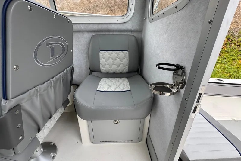 Slide: The Image of 2026 Defiance Admiral 220 EX interior with gray seating and cup holder. - 32