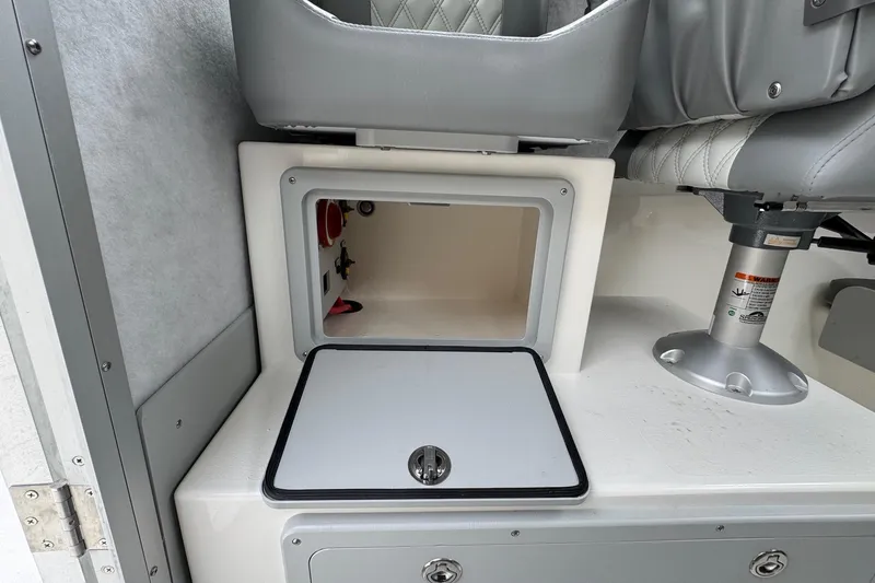 Slide: The Image of Open storage compartment in 2026 Defiance Admiral 220 EX boat interior. - 39