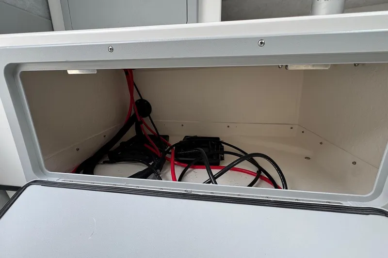 Slide: The Image of Storage compartment with cables in 2026 Defiance Admiral 220 EX boat. - 41