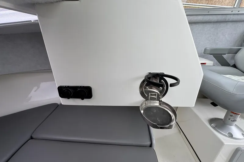 Slide: The Image of Interior of 2026 Defiance Admiral 220 EX boat, featuring seating and control panel. - 43