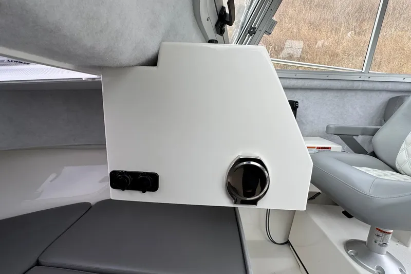 Slide: The Image of Interior of 2026 Defiance Admiral 220 EX boat, featuring seating and control panel. - 44