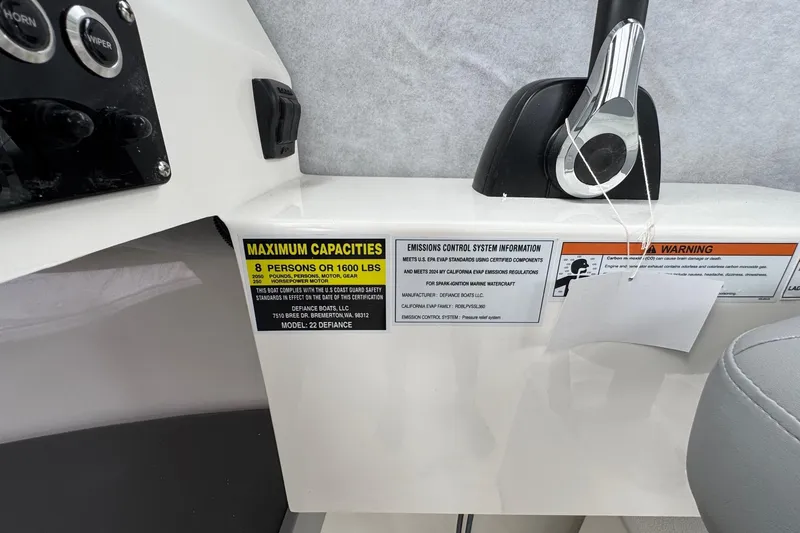 Slide: The Image of Control panel of 2026 Defiance Admiral 220 EX boat with capacity and emissions labels. - 46