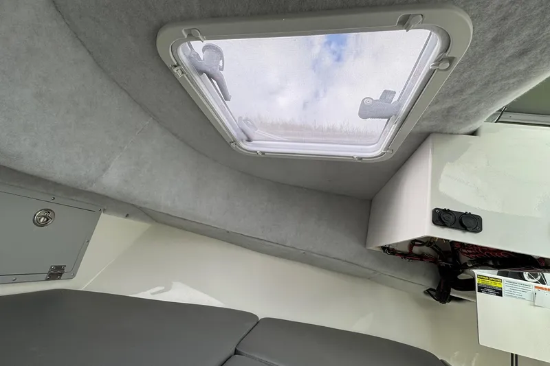 Slide: The Image of Interior cabin view of 2026 Defiance Admiral 220 EX boat with skylight and storage. - 54