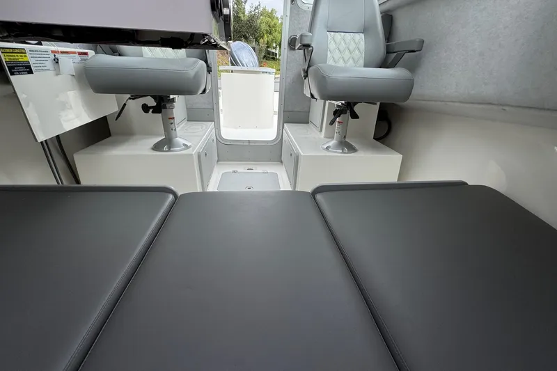 Slide: The Image of 2026 Defiance Admiral 220 EX interior with cushioned seating and swivel chairs. - 55