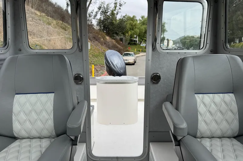 Slide: The Image of Interior view of 2026 Defiance Admiral 220 EX boat with gray seating. - 56