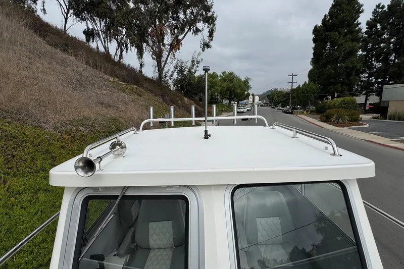 Slide: The Image of 2026 Defiance Admiral 220 EX boat roof with horn and railings on a street. - 60