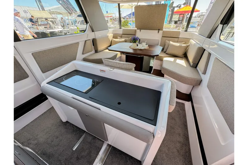Slide: The Image of Interior of 2024 Axopar 45 XC Cross Cabin with modern seating and dining area. - 10