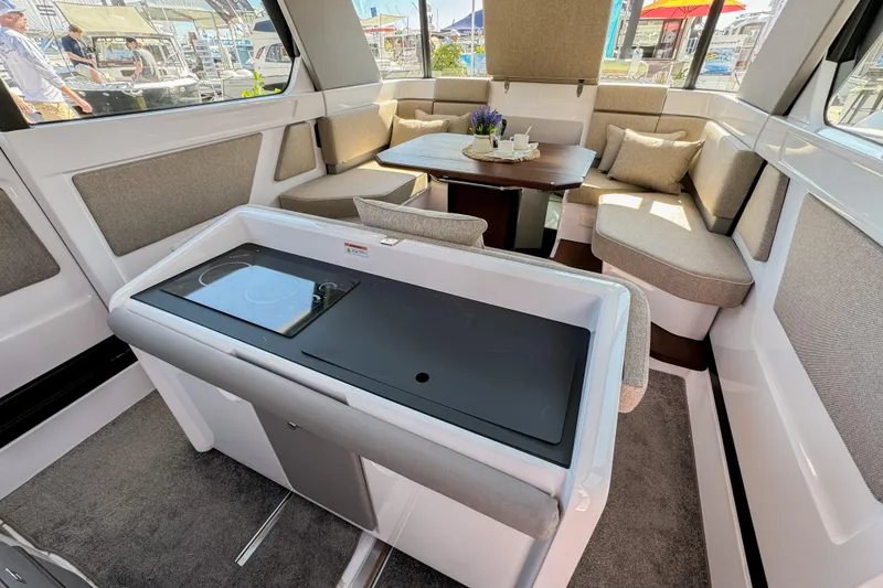 Slide: The Image of Luxurious interior of 2024 Axopar 45 XC Cross Cabin with modern seating and kitchenette. - 10