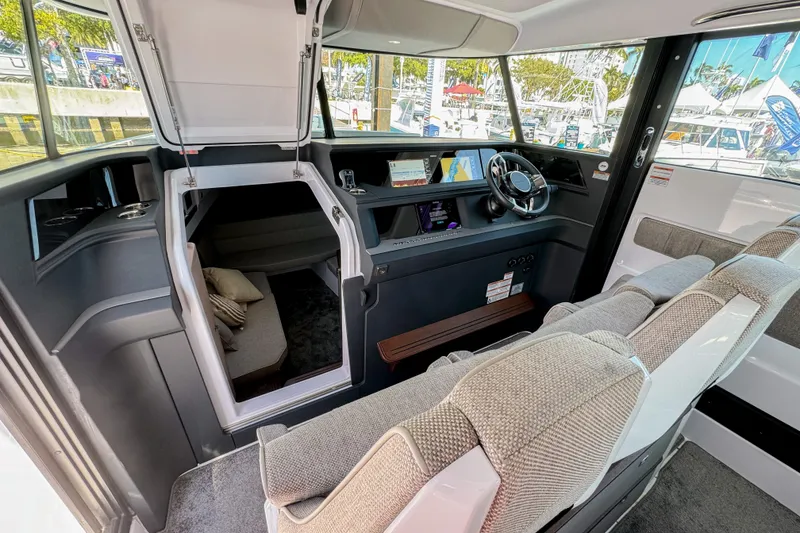 Slide: The Image of 2024 Axopar 45 XC Cross Cabin interior with modern helm, seating, and cabin access. - 19