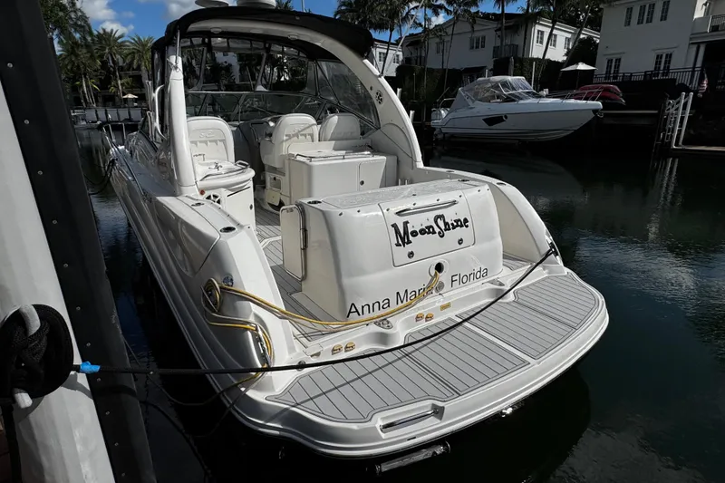 Slide: The Image of 2006 Sea Ray 340 Sundancer docked in a marina, rear view. - 13