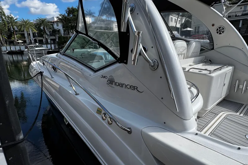 Slide: The Image of 2006 Sea Ray 340 Sundancer docked, showcasing sleek design and luxurious interior. - 15