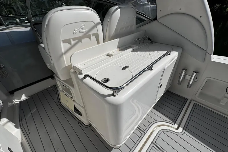 Slide: The Image of 2006 Sea Ray 340 Sundancer cockpit with seating and storage, featuring sleek design and functionality. - 20