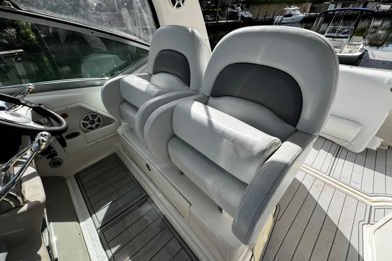 Slide: The Image of 2006 Sea Ray 340 Sundancer cockpit with dual helm seats and steering wheel. - 22