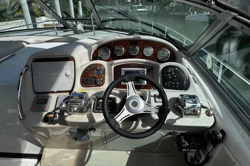 Slide: The Image of Helm of 2006 Sea Ray 340 Sundancer with steering wheel and control panel. - 23