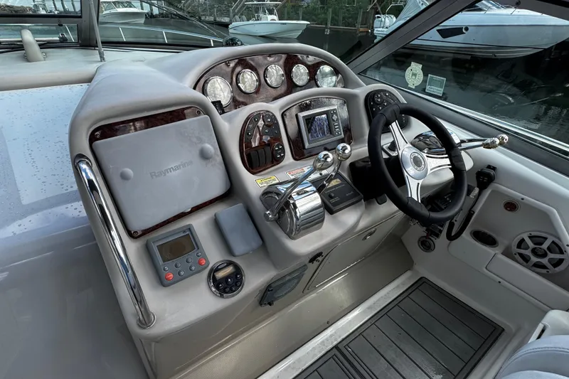 Slide: The Image of Cockpit of 2006 Sea Ray 340 Sundancer with steering wheel and navigation controls. - 24