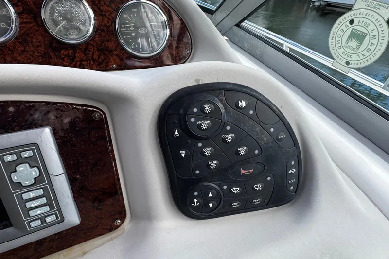 Slide: The Image of Control panel of a 2006 Sea Ray 340 Sundancer boat with various switches and gauges. - 28