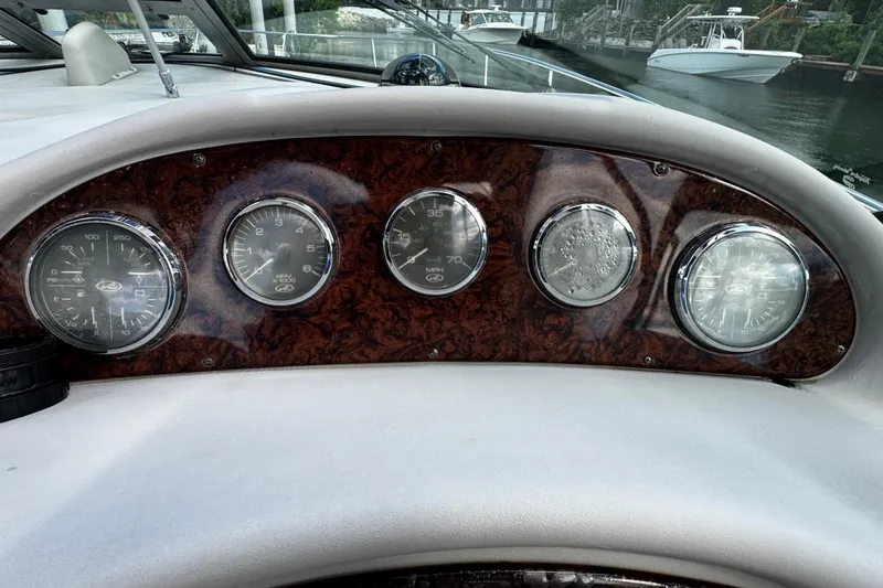 Slide: The Image of Dashboard of 2006 Sea Ray 340 Sundancer boat with gauges and wood paneling. - 29
