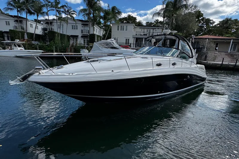 Slide: The Image of 2006 Sea Ray 340 Sundancer yacht docked in a scenic waterfront setting. - 3