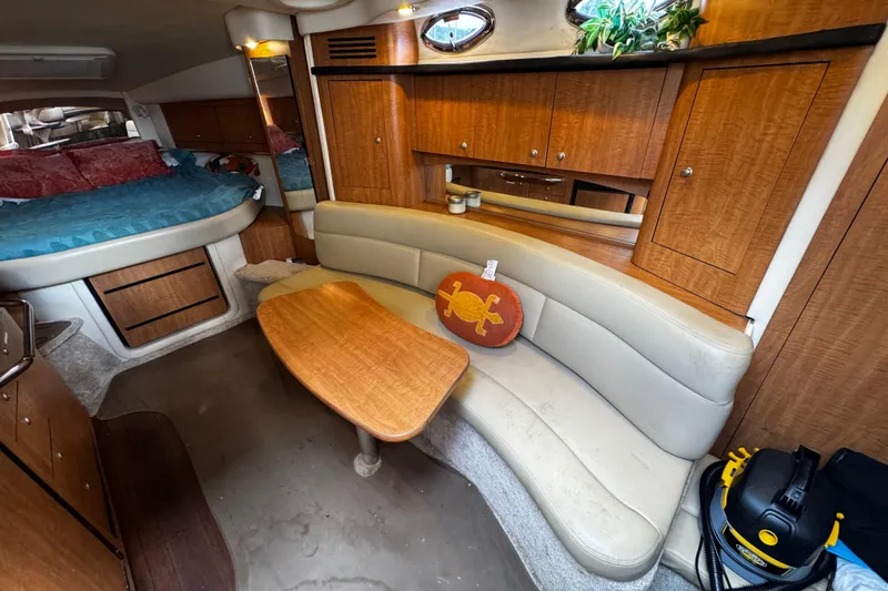 Slide: The Image of 2006 Sea Ray 340 Sundancer cabin interior with seating, table, and bed. - 31