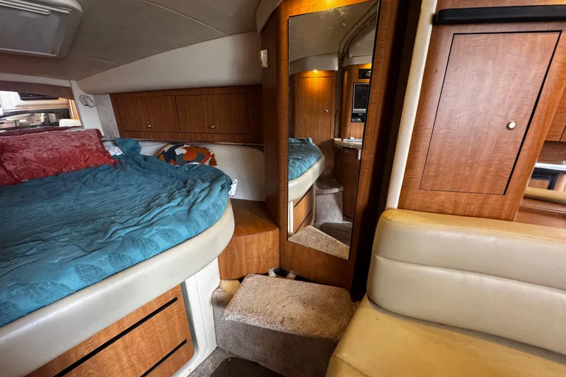 Slide: The Image of Interior of 2006 Sea Ray 340 Sundancer with cozy bed and wooden cabinetry. - 35
