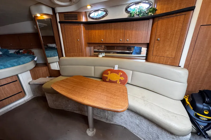 Slide: The Image of 2006 Sea Ray 340 Sundancer cabin interior with wood cabinetry and curved seating. - 36