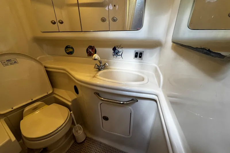 Slide: The Image of 2006 Sea Ray 340 Sundancer bathroom with sink, toilet, and storage cabinets. - 38