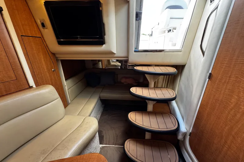 Slide: The Image of Interior of 2006 Sea Ray 340 Sundancer with wooden steps and beige seating. - 41