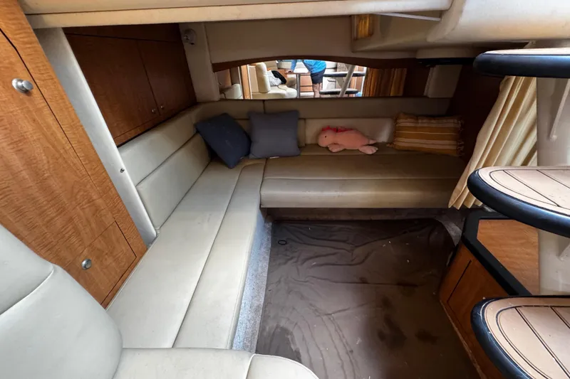 Slide: The Image of Interior of 2006 Sea Ray 340 Sundancer with beige seating and wooden cabinetry. - 43