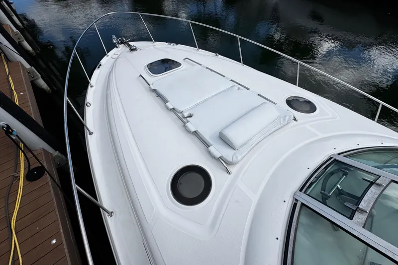 Slide: The Image of 2006 Sea Ray 340 Sundancer yacht deck with sunbathing cushions and portholes. - 49