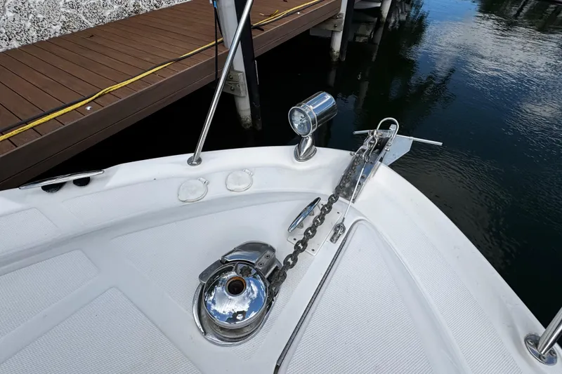 Slide: The Image of Bow of 2006 Sea Ray 340 Sundancer with anchor chain and spotlight near dock. - 52