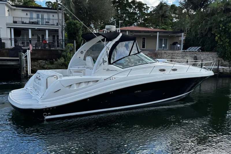 Slide: The Image of 2006 Sea Ray 340 Sundancer yacht docked near waterfront homes. - 7